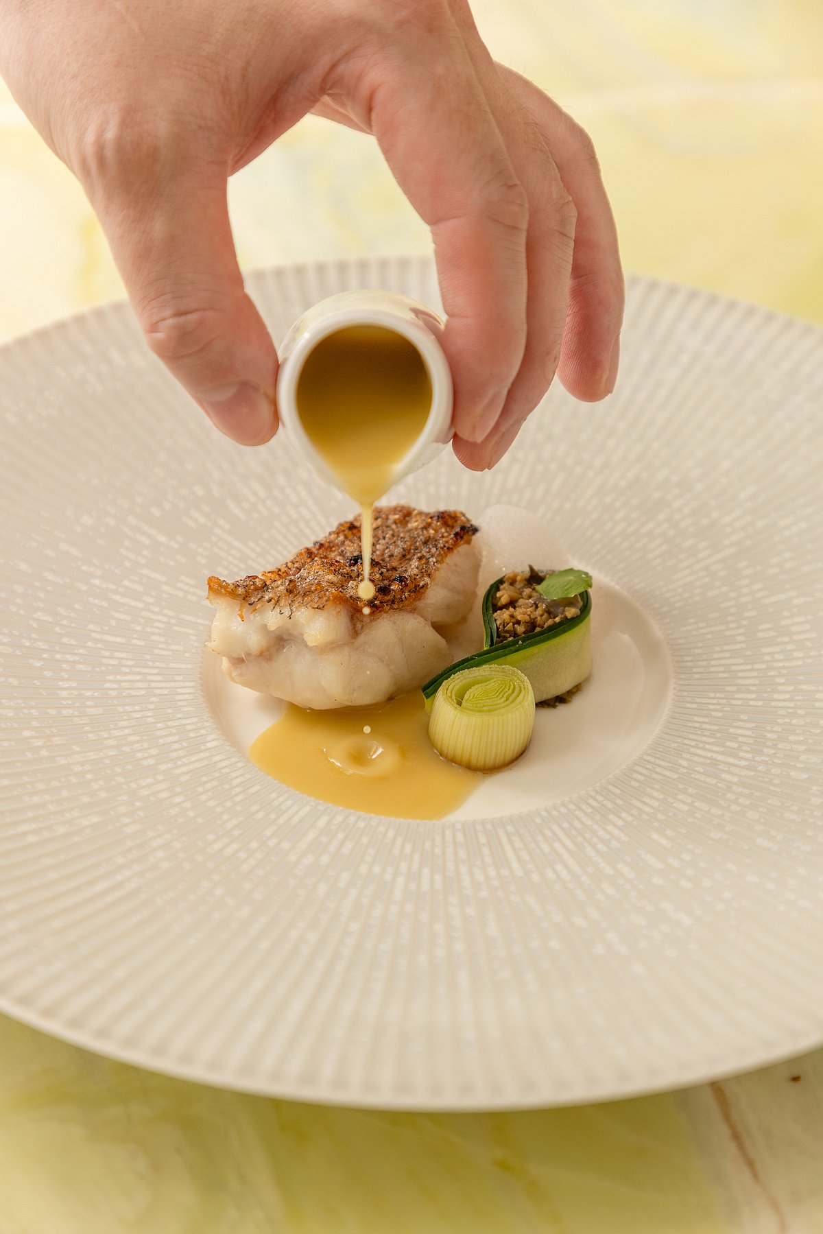 Charcoal grilled blue grouper with green olive sauce and oolong tea foam